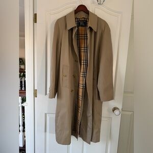 Burberry tan trench with classic plaid lining.
Men’s trenchcoat. Jacket / coat